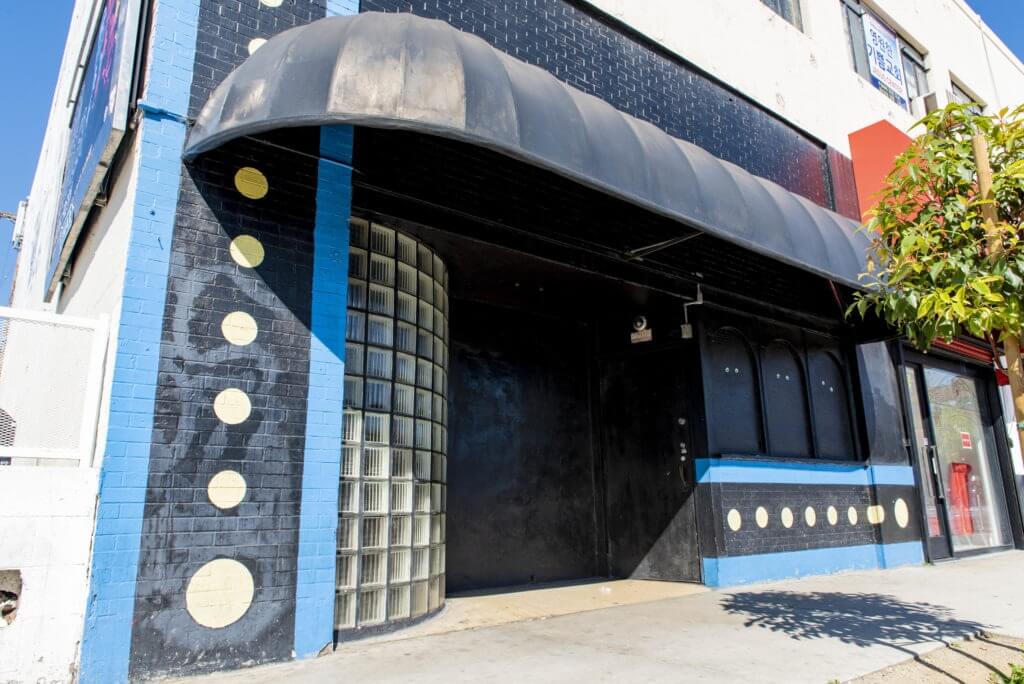 Facade of building with curved glass brick wall on Western Avenue.