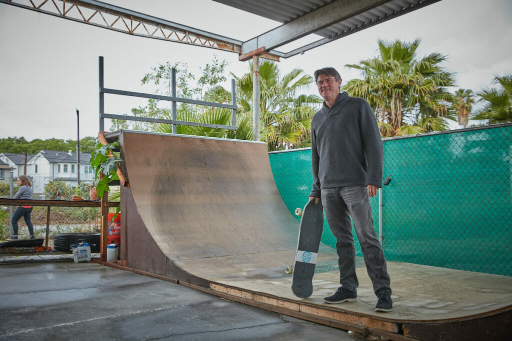 Adam Fincham posing with a skateboard.