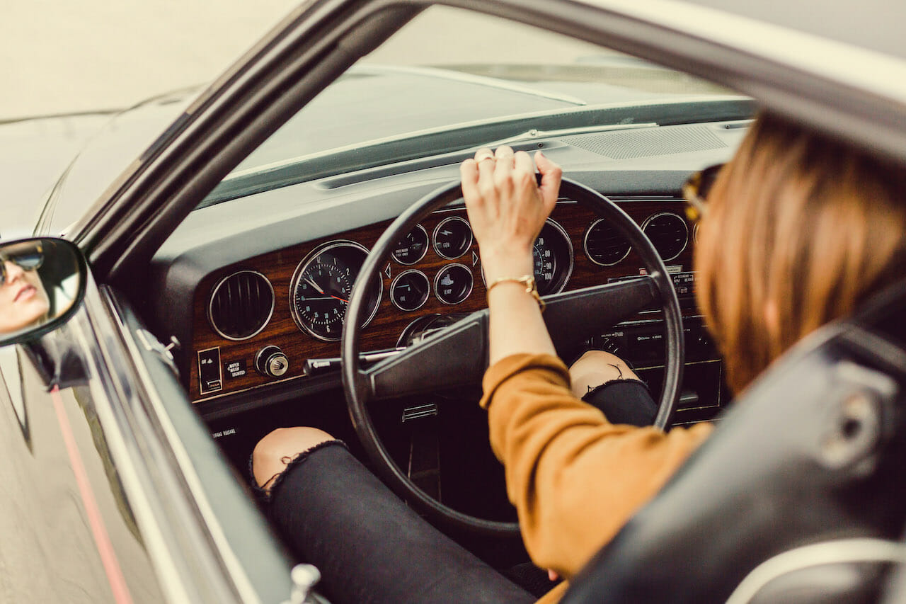 woman driving vintage car