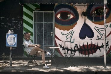 Mike Anaya wears a furry animal mask while waiting outside Tacos Tu Madre in Los Feliz.