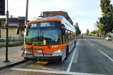 The front of a Metro bus waiting at a stop.