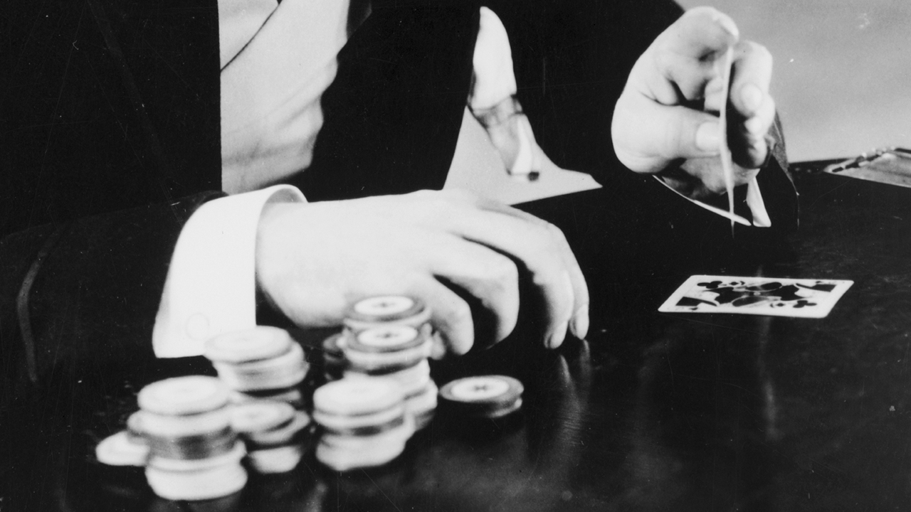 A man playing cards and gambling.