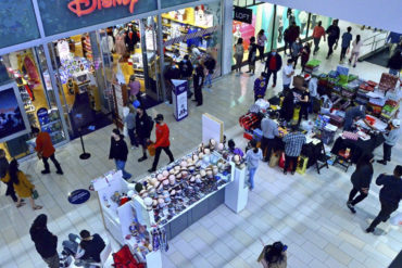 Masked shoppers make their way through Glendale Galleria on Wednesday, Dec. 23, 2020.